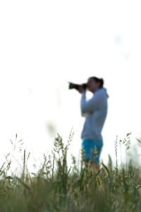 man in white shirt and blue pants carrying a baby in blue shirt