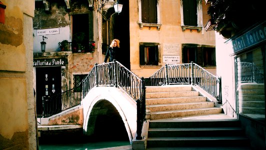 woman standing near railings beside concrete stairs photo