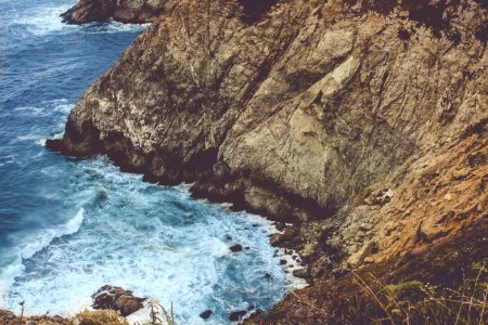 brown mountain in front of sea