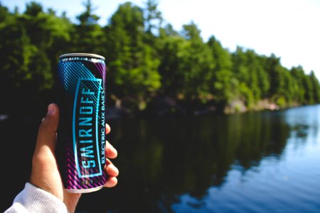 person holding Smirnoff can