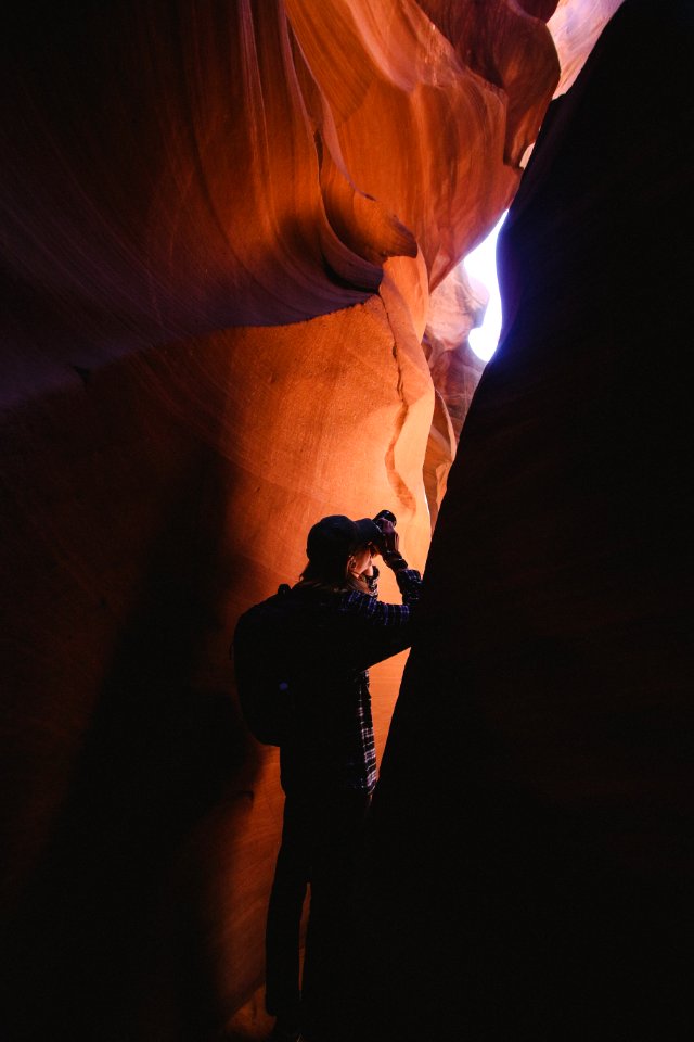 man standing inside cave photo
