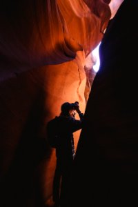 man standing inside cave photo