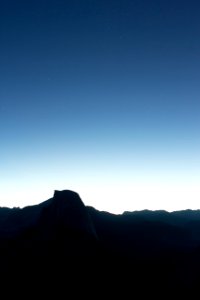 silhouette of mountain under blue sky during daytime photo