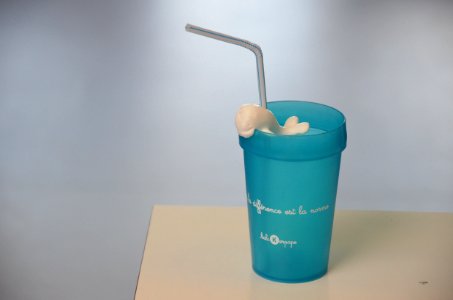 A blue cup with a straw.