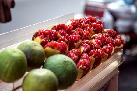 green and red fruits on white wooden shelf photo
