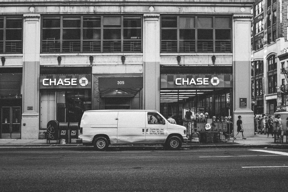 white van parked beside building