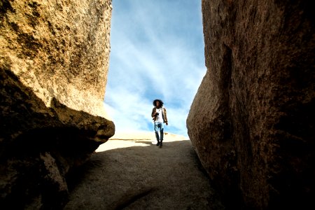 man walking near rock