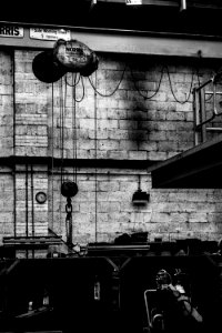 grayscale photography of wall with ropes and machine photo