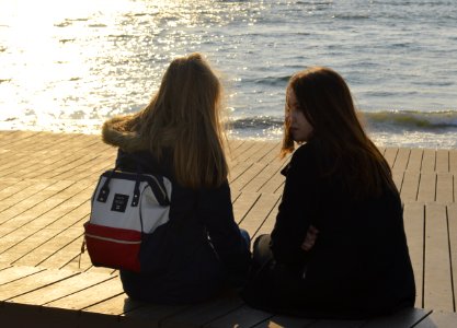 Russia, Vladivostok, Teenager girls sitting photo