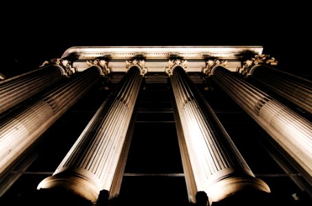 Staring up at the tall pillars in front of a courthouse. photo