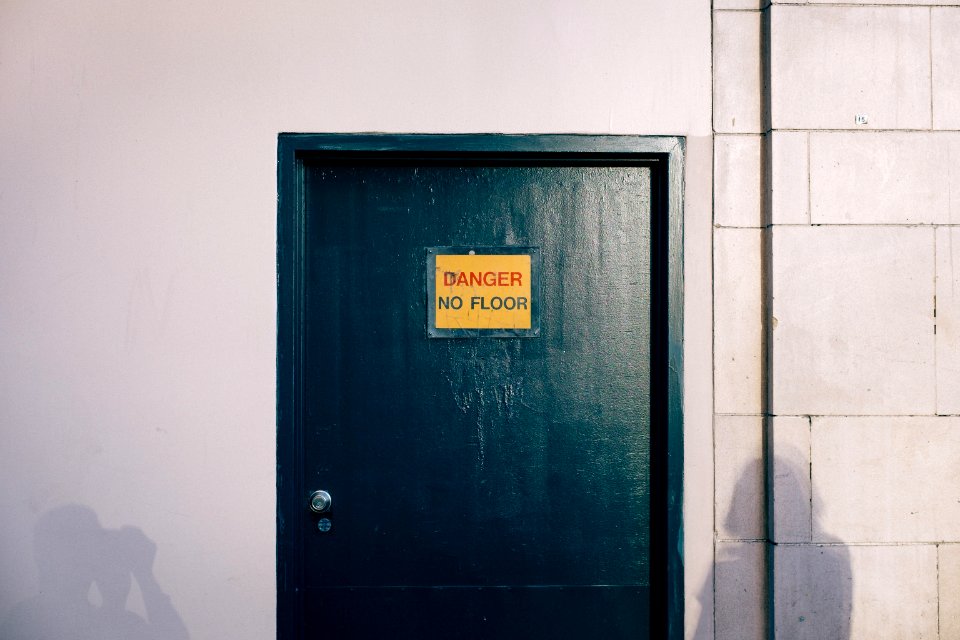 blue wooden door with gold and black signage