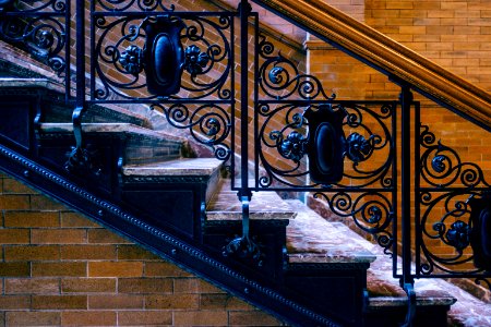 black metal railings on brown concrete staircase