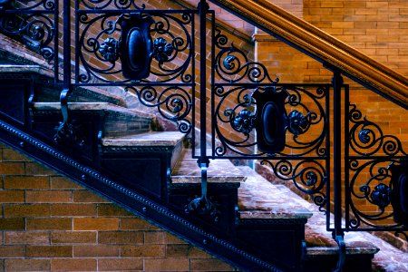 black metal railings on brown concrete staircase photo