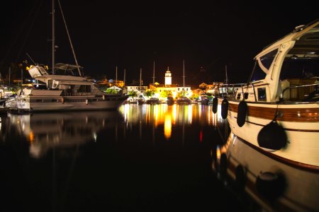 white and black boat on dock during night time photo