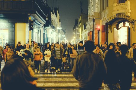 people walking on street during night time photo