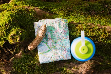 world map beside blue and green tumbler