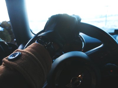 person holding black steering wheel photo