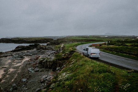 white van parked besides concrete road