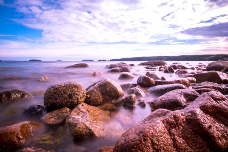 brown rocks beside beach photo