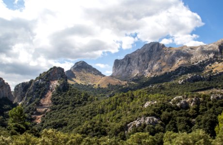 green and brown mountain under white clouds during daytime photo