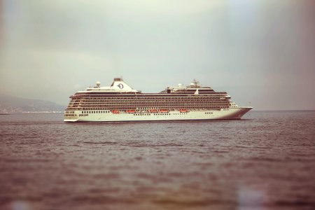 white cruise ship on sea under white sky during daytime photo