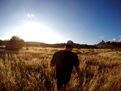 A man walking through a country field. photo