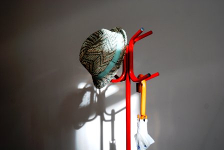 Hat , Umbrella on the floor hanger with its shadow on the Walland, Moscow photo