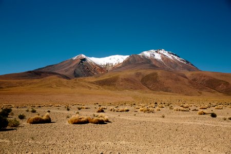 A snowy mountain in the desert photo