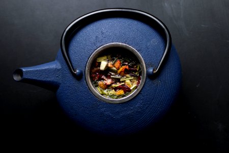 Blue kettle filled with herbs 