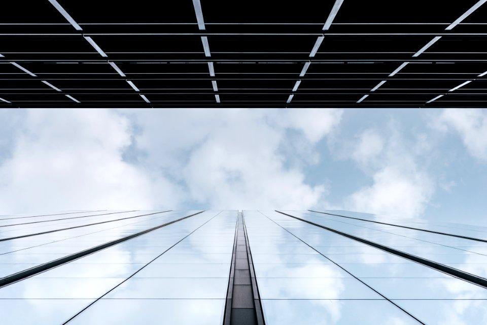 Clouds in a tall glass facade 