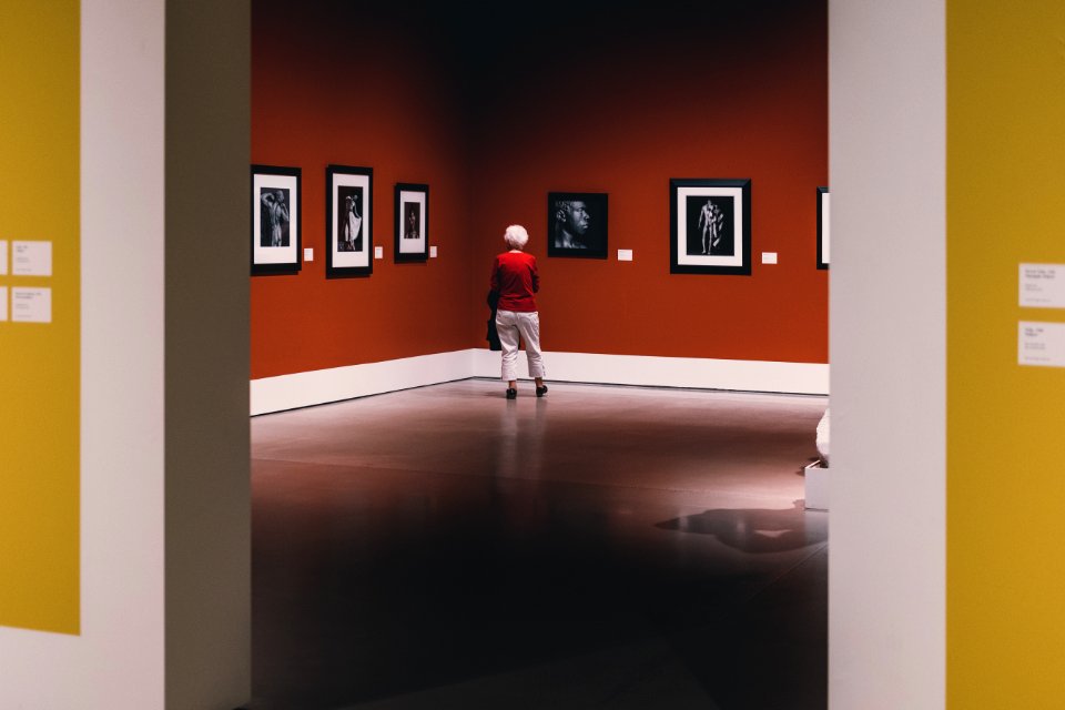 Elderly woman gazing at art 