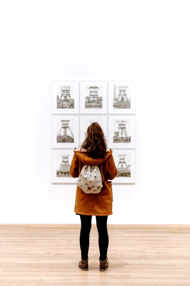 Girl with backpack in art gallery 