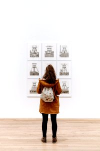 Girl with backpack in art gallery photo