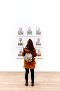 Girl with backpack in art gallery 