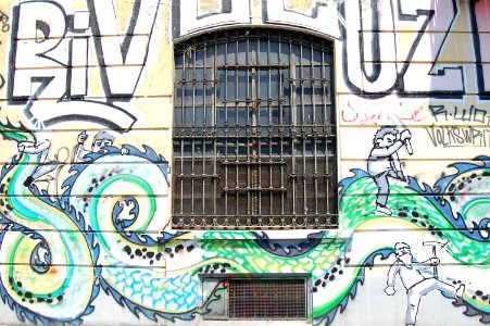 Graffiti surrounds building window photo