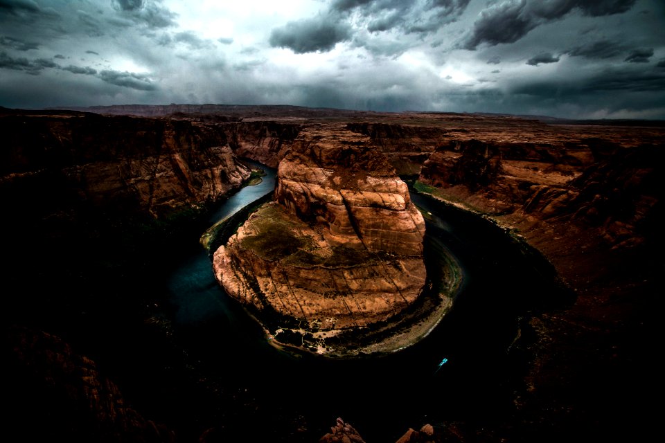 Horseshoe river bend under dark clouds photo