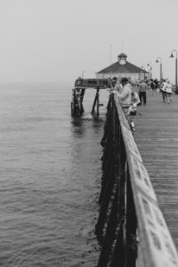 People fishing on a pier photo