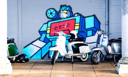 Scooters in front of graffiti photo