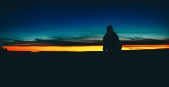 Silhouette person standing with horizon photo