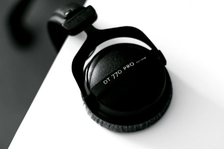 Top view of headphones hanging from a desk photo