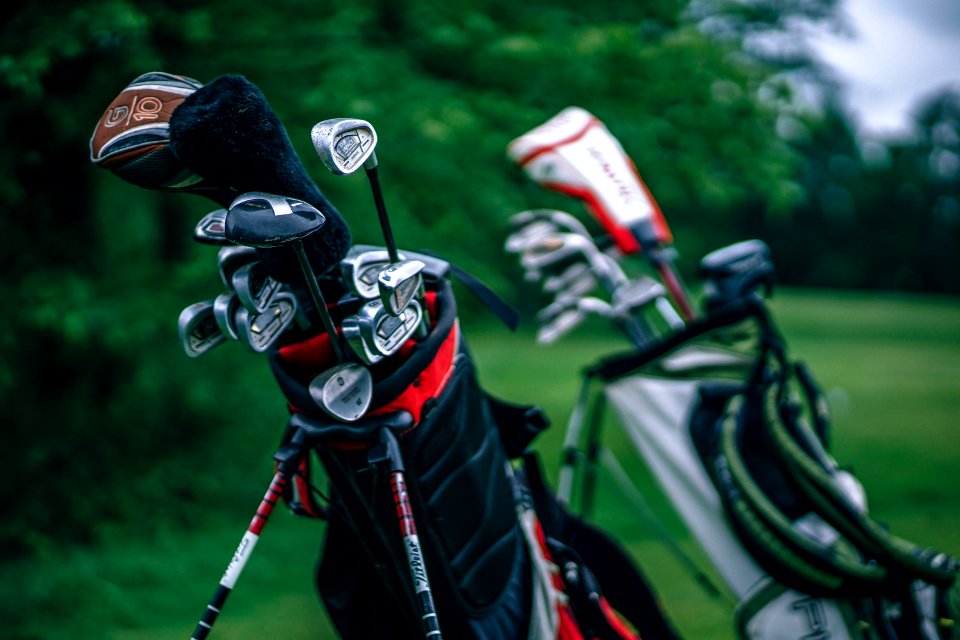 Two bags full of golf clubs 