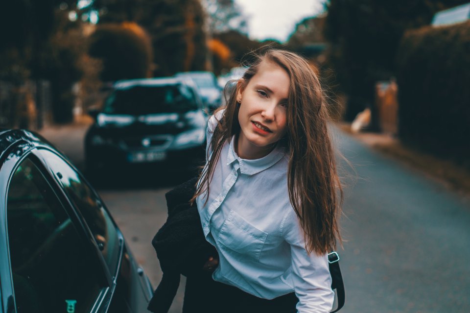 Woman leaning by the car in Hamburg 