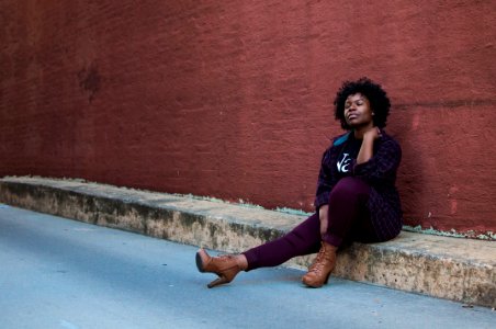 Woman sitting on curb 