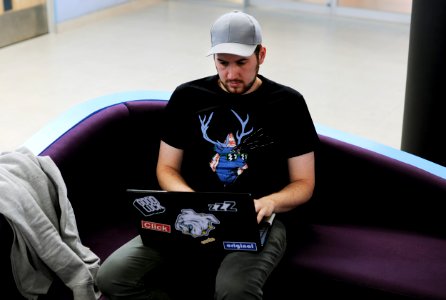 Young man working on a couch photo