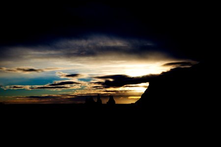 Silhouette of Rock Formations Under Cloudy Sky photo