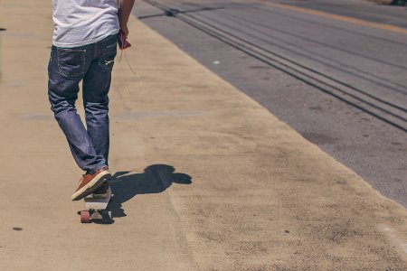 Man Riding Skateboard on Road photo