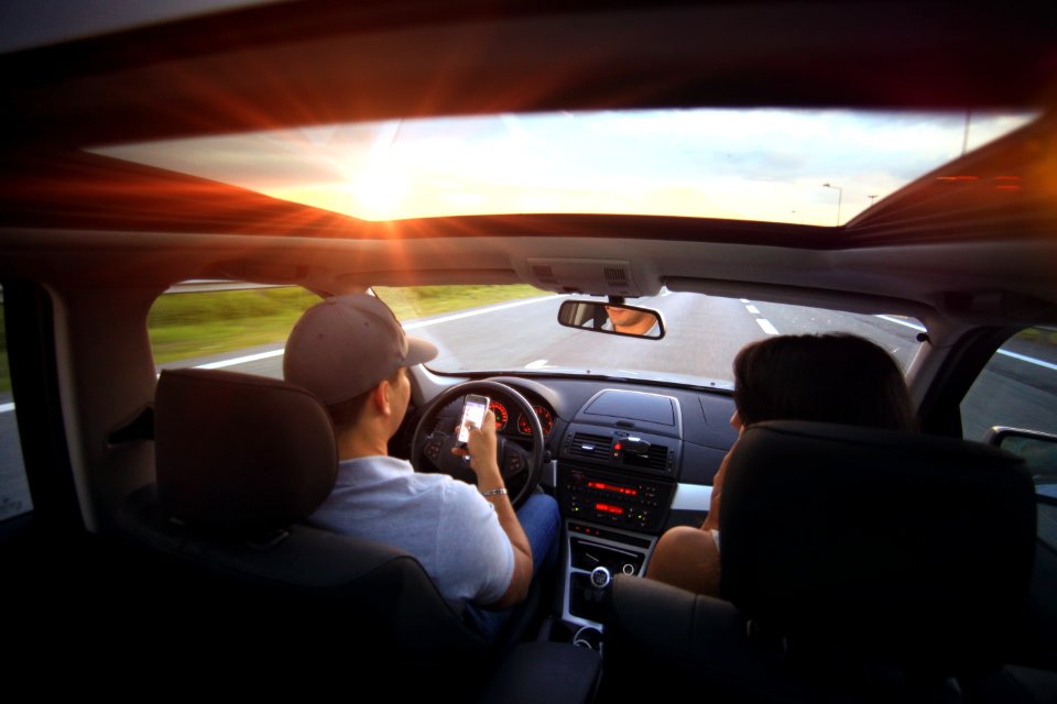 Man Using Smartphone While Driving photo