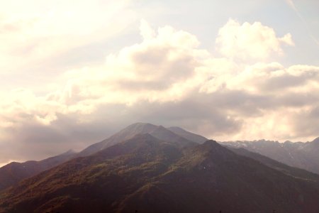 Green and Brown Mountain Peak With White Clouds