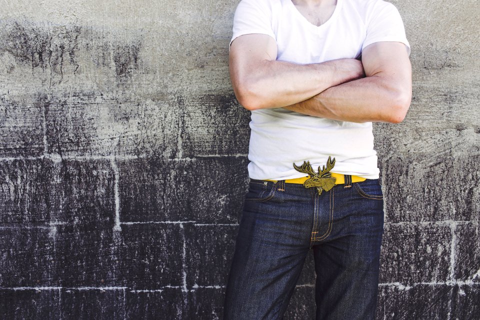 Man Leaning on Gray Wall photo