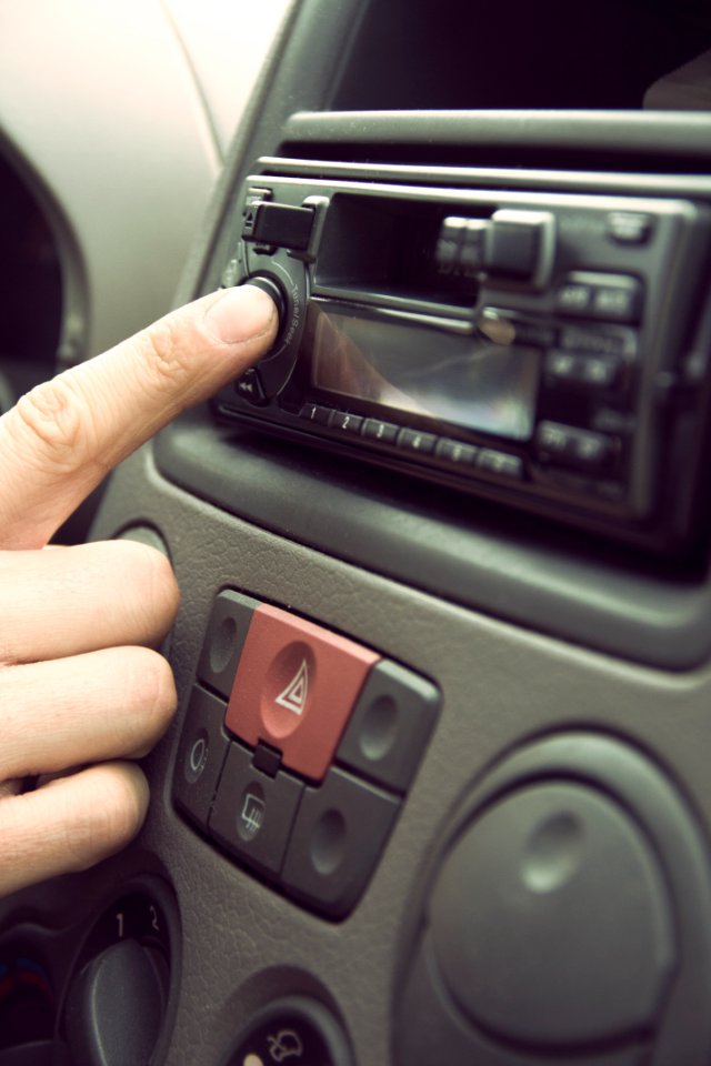 Person Touching 1-din Head Unit Button photo